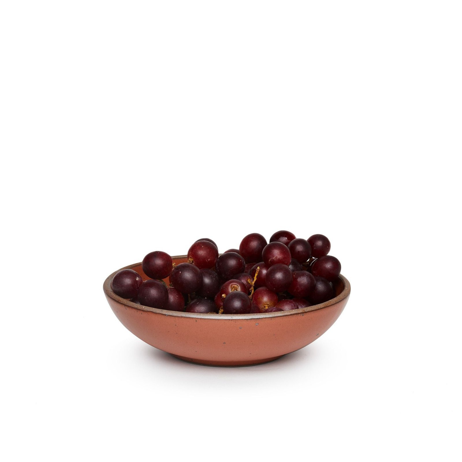 Verllage daily bowl in Terracotta, shown with grapes