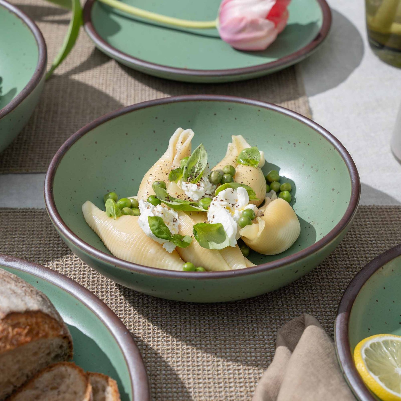 Verllage daily bowl in Viridian, shown with pasta in a table setting